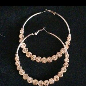 Large gold tone hoops with pink jewels